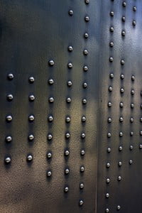 Detail entree met brons op houten deur gespoten